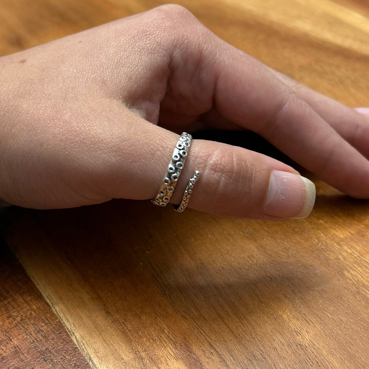 Octopus thumb ring worn on hand