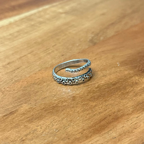 Octopus thumb ring on wooden surface